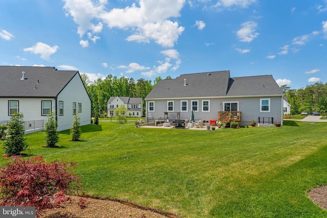 back of house featuring a patio and a lawn