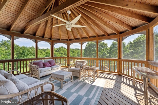 deck featuring outdoor lounge area, a gazebo, a ceiling fan, and view of wooded area