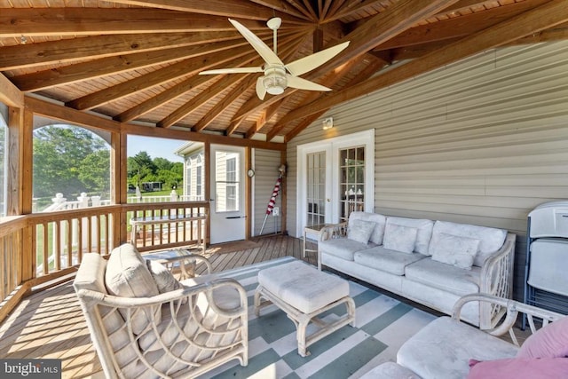 wooden terrace featuring french doors, ceiling fan, and an outdoor living space