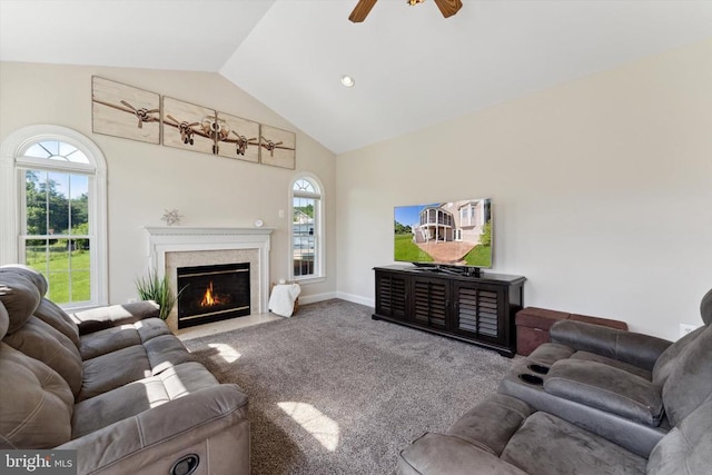 living room featuring carpet, plenty of natural light, a ceiling fan, a premium fireplace, and high vaulted ceiling