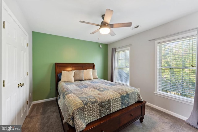 bedroom with carpet floors, baseboards, ceiling fan, and a closet