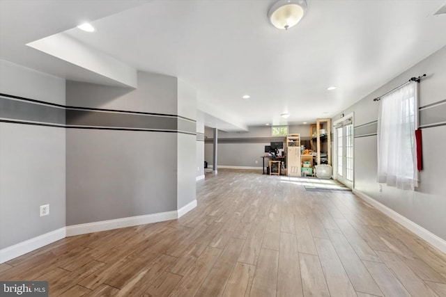 unfurnished living room featuring light wood finished floors, baseboards, and recessed lighting