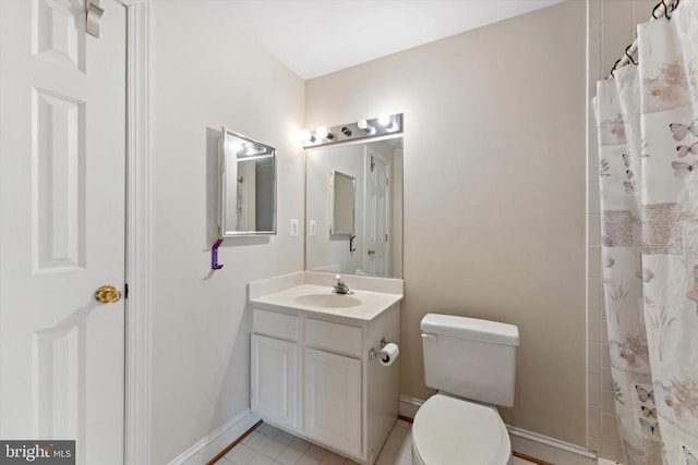 full bath featuring toilet, baseboards, vanity, curtained shower, and tile patterned flooring