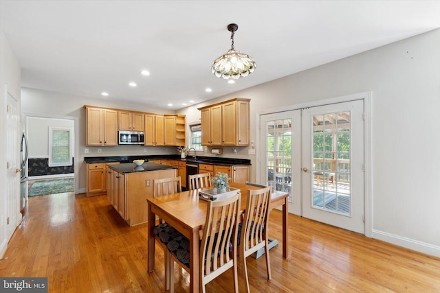 dining space featuring light wood-style floors, french doors, plenty of natural light, and recessed lighting