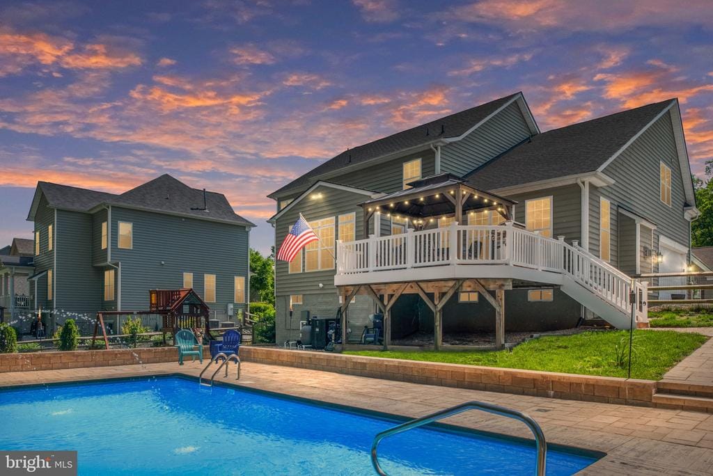 12133 Sawhill Blvd, Spotsylvania, VA 22553 - rear view of house with a deck, stairway, a patio area, an outdoor pool, and a yard