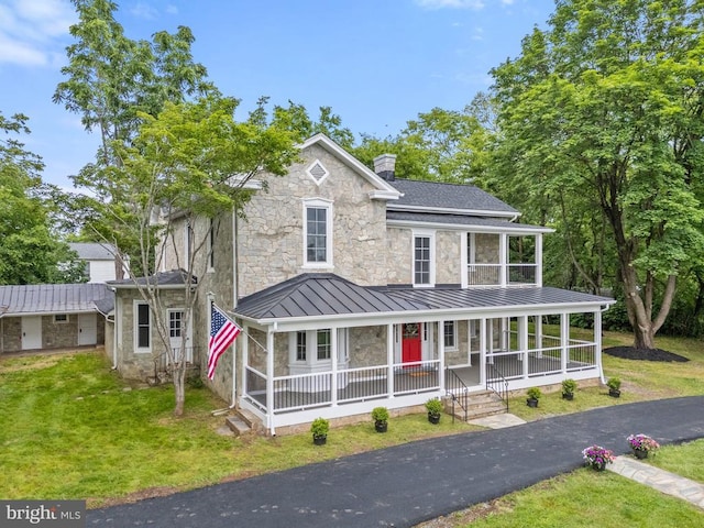 105 E Washington St, Remington, VA 22734 - view of front of home with covered porch, a standing seam roof, stone siding, a chimney, and a front lawn