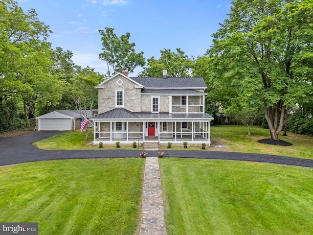 105 E Washington St, Remington, VA 22734 - view of front facade featuring a porch, an outdoor structure, a standing seam roof, a chimney, and a front lawn