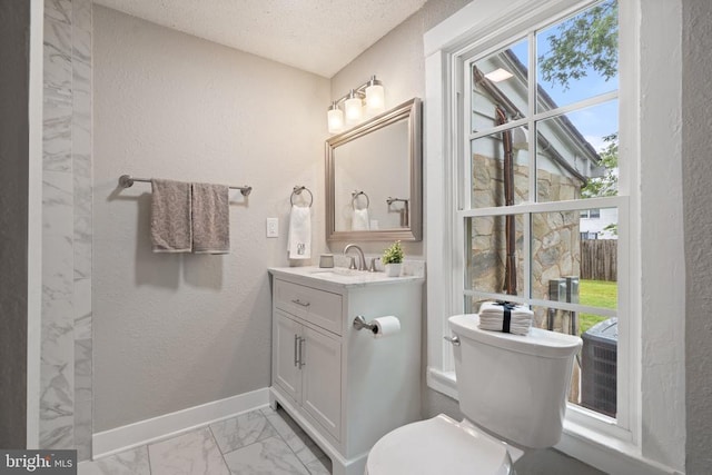 105 E Washington St, Remington, VA 22734 - bathroom featuring marble look tiles, a textured wall, vanity, plenty of natural light, and a textured ceiling