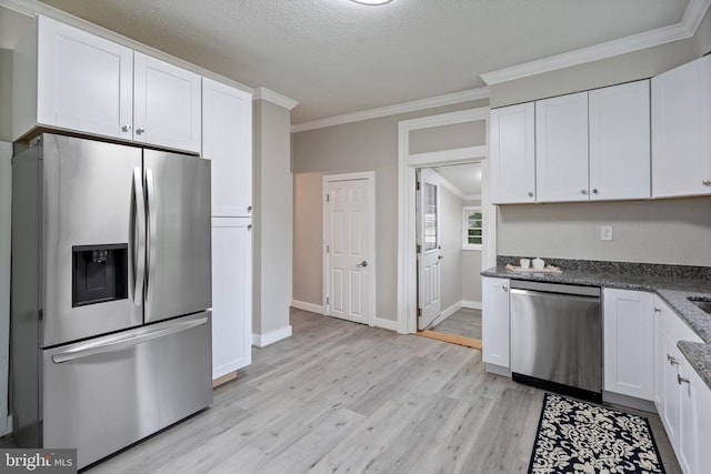 105 E Washington St, Remington, VA 22734 - kitchen featuring appliances with stainless steel finishes, light wood-style flooring, white cabinets, crown molding, and a textured ceiling