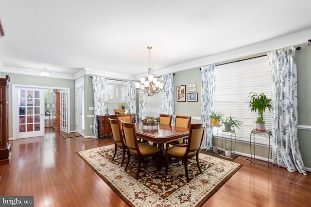6020 E Greenbrier River Rd E, Fredericksburg, VA 22407 - dining space with a chandelier, crown molding, hardwood / wood-style floors, baseboards, and french doors