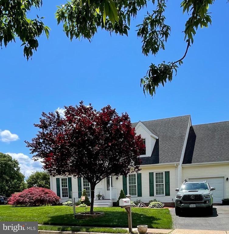  - view of front of house with a front lawn, a garage, and a shingled roof