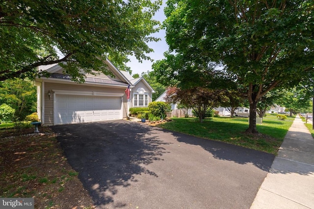 view of front of property with driveway, an outdoor structure, a garage, and a front yard