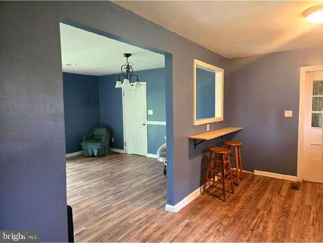 dining space featuring wood finished floors and baseboards