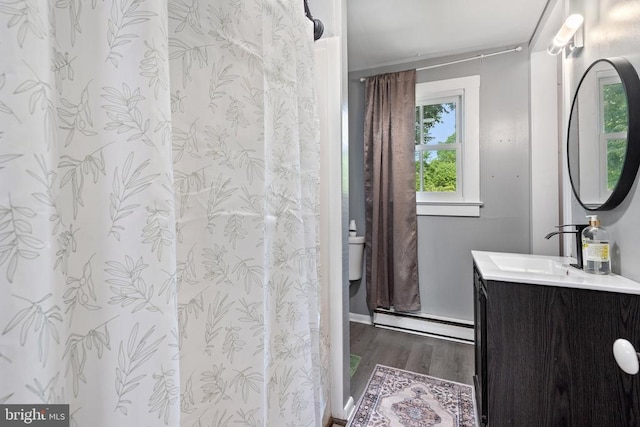 404 N Franklin St, Remington, VA 22734 - full bath with baseboard heating, vanity, wood finished floors, and a shower with shower curtain