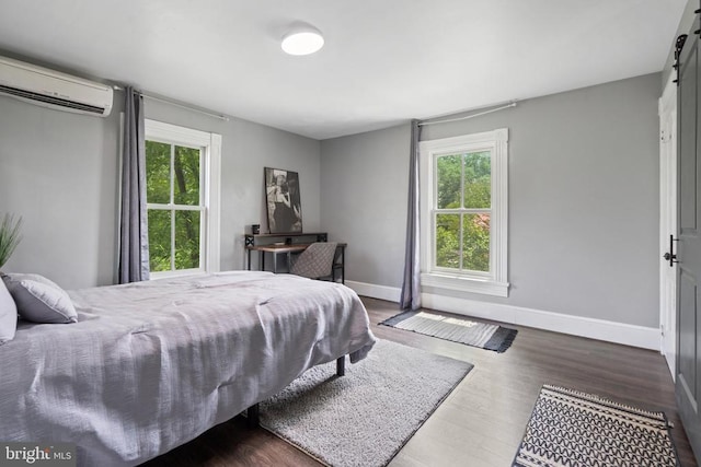 404 N Franklin St, Remington, VA 22734 - bedroom featuring a wall unit AC, multiple windows, and wood finished floors