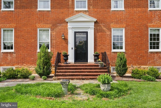  - property entrance featuring brick siding