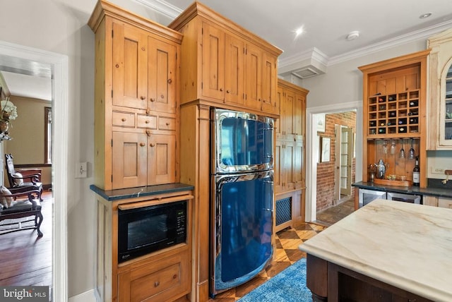  - kitchen with black microwave, refrigerator, and ornamental molding