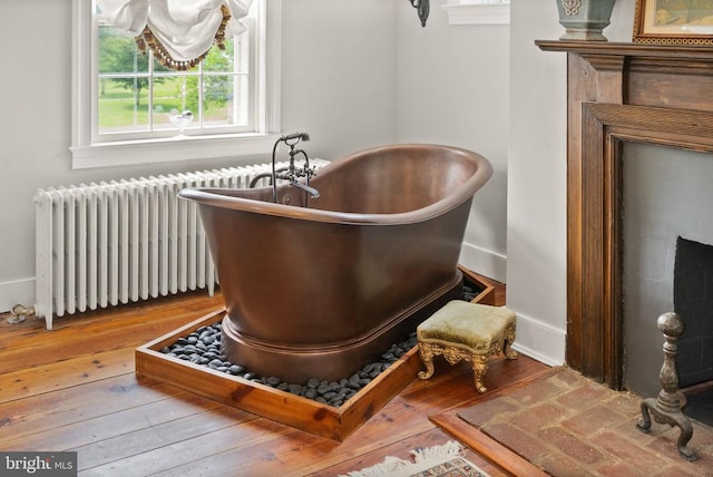 - detailed view of radiator and wood finished floors