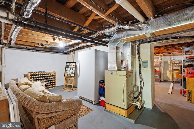  - unfinished basement with freestanding refrigerator and heating unit