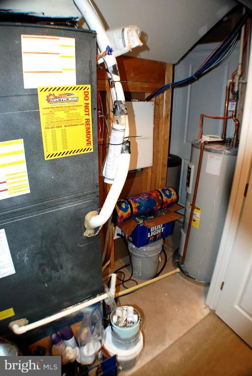 - utility room with electric water heater and heating unit
