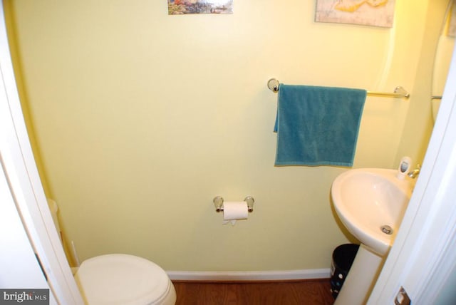  - bathroom with baseboards and wood finished floors
