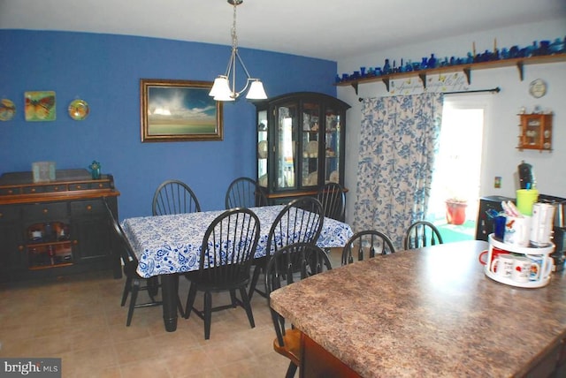  - dining room featuring a chandelier