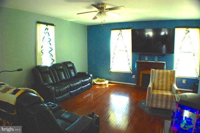  - living area featuring plenty of natural light, wood finished floors, and ceiling fan