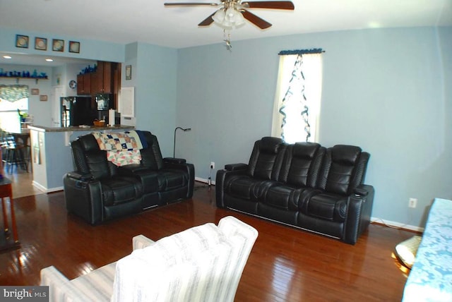  - living room with a ceiling fan and wood finished floors