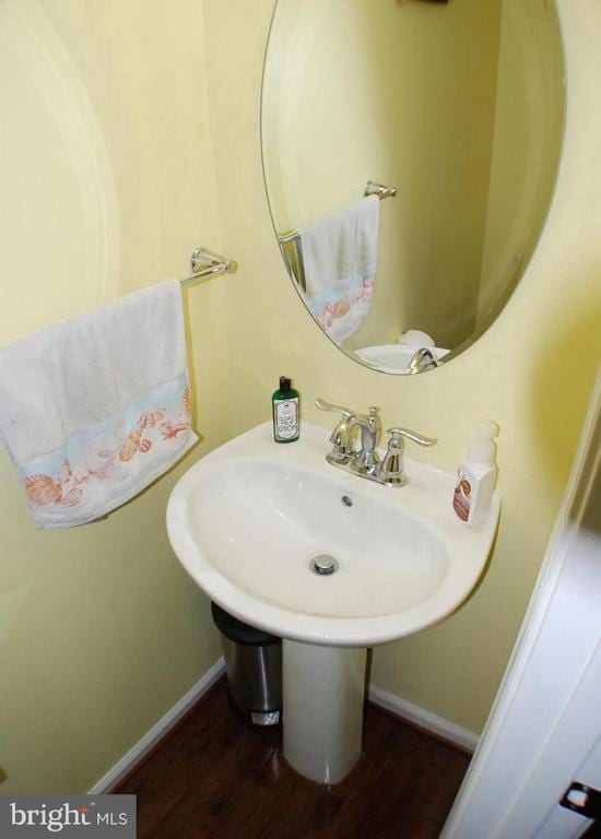  - bathroom featuring wood finished floors and baseboards