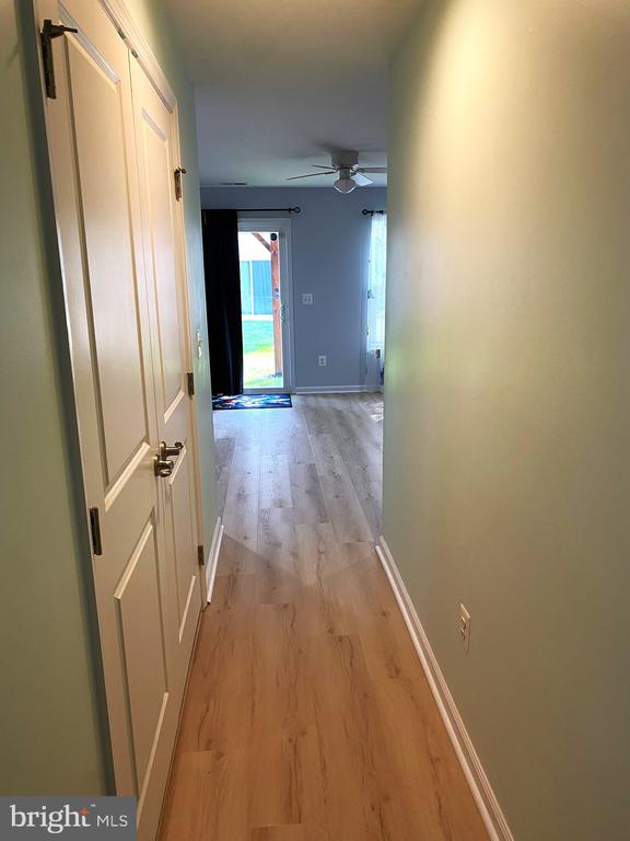  - hall with light wood-type flooring and baseboards