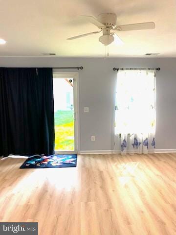  - empty room featuring wood finished floors and a ceiling fan