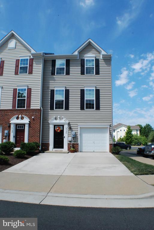  - view of front facade featuring concrete driveway, a garage, and brick siding