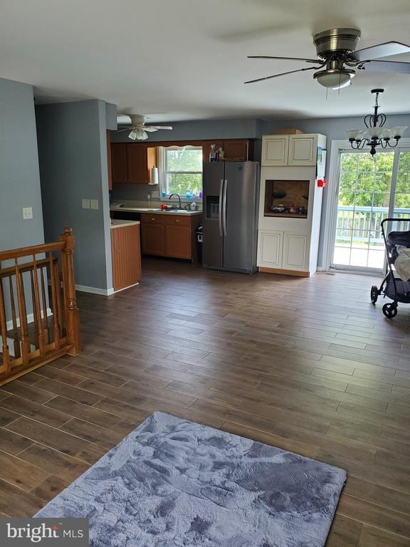  - kitchen with stainless steel refrigerator with ice dispenser, a ceiling fan, dark wood-style flooring, and light countertops