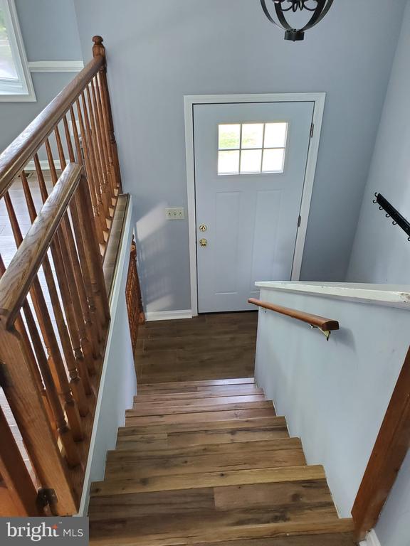  - stairway with wood finished floors and baseboards