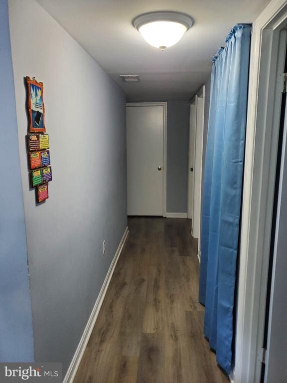  - corridor featuring wood finished floors and baseboards