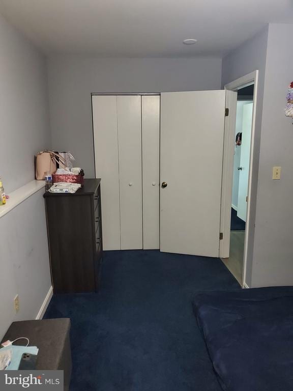  - bedroom featuring dark colored carpet and a closet