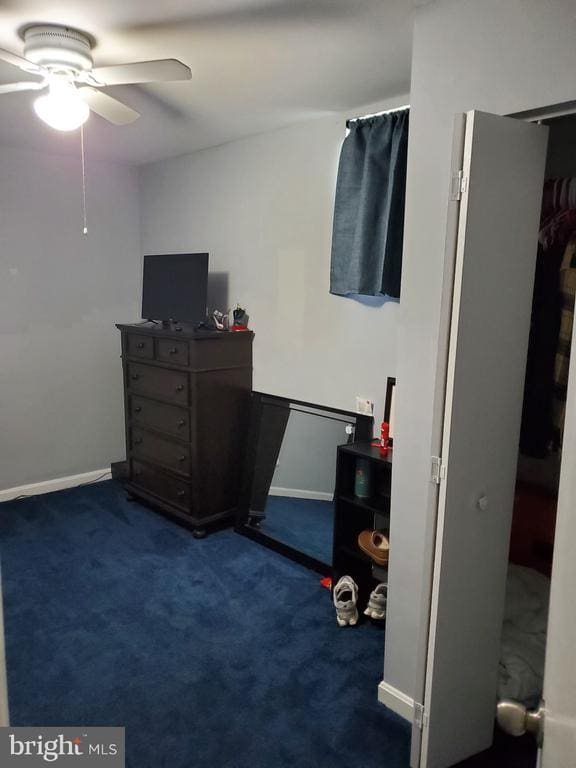  - bedroom with dark colored carpet and a ceiling fan