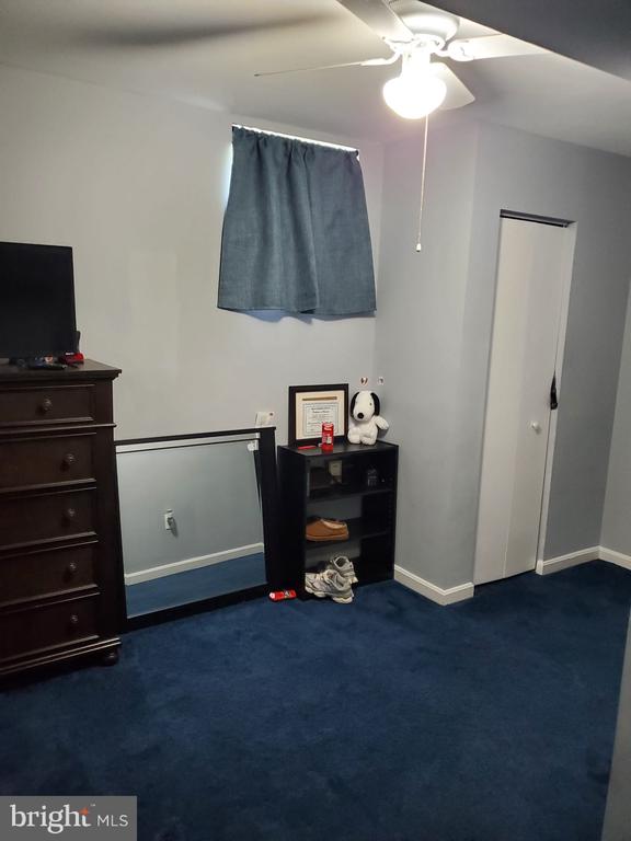  - bedroom featuring dark colored carpet and a ceiling fan