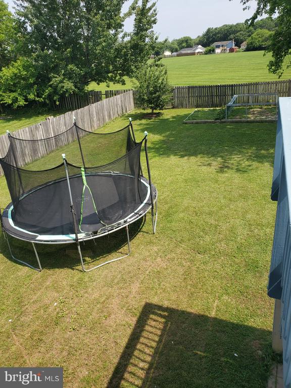  - fenced backyard featuring a trampoline