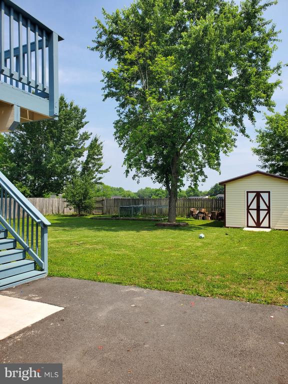  - fenced backyard with a storage shed