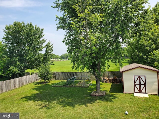  - fenced backyard with a storage shed and a vegetable garden