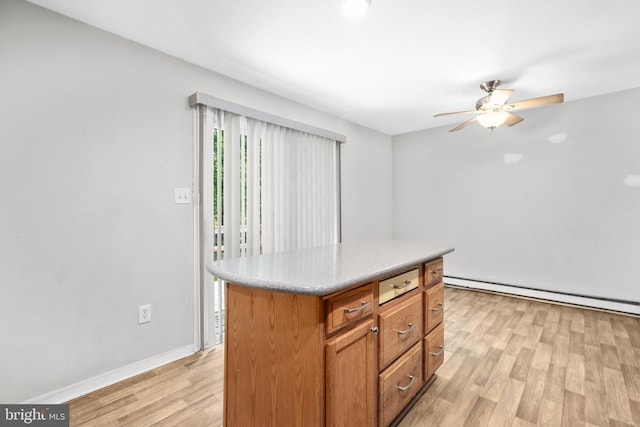 221 Hampton Dr, Spotsylvania, VA 22551 - kitchen with a baseboard heating unit, light wood-style flooring, ceiling fan, light countertops, and a center island