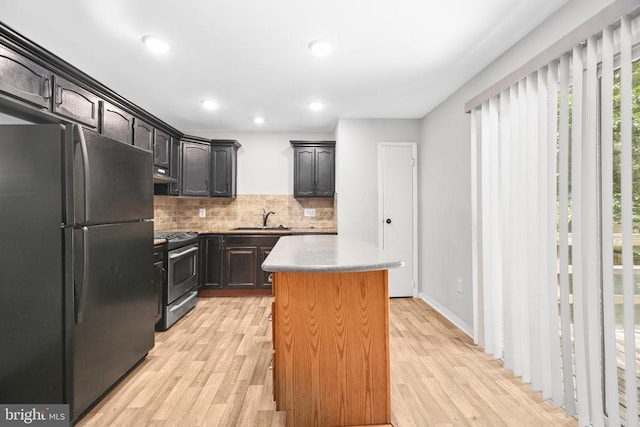 221 Hampton Dr, Spotsylvania, VA 22551 - kitchen featuring freestanding refrigerator, stainless steel stove, light wood-type flooring, a center island, and recessed lighting