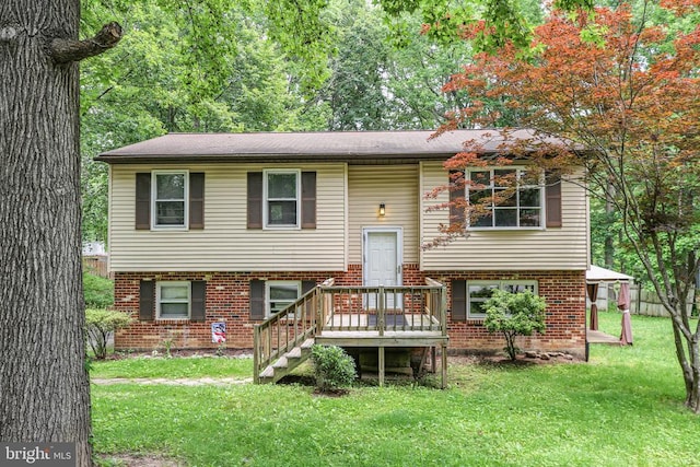 221 Hampton Dr, Spotsylvania, VA 22551 - raised ranch featuring brick siding, a front lawn, and a deck