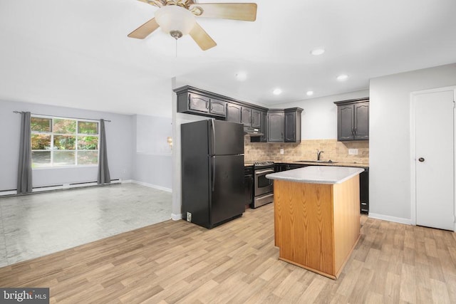 221 Hampton Dr, Spotsylvania, VA 22551 - kitchen with freestanding refrigerator, stainless steel range, under cabinet range hood, decorative backsplash, and light countertops
