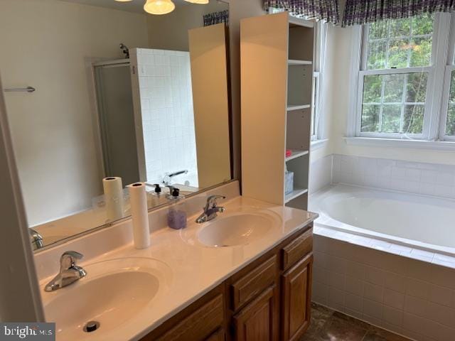 bathroom with a bath, double vanity, an enclosed shower, and tile patterned flooring