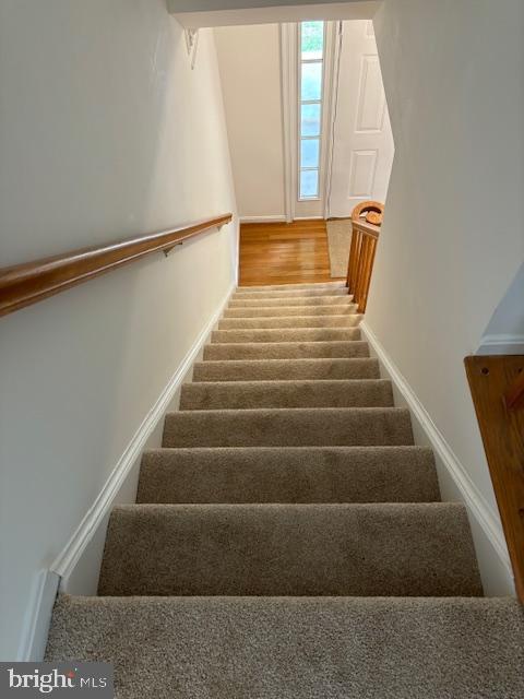 staircase featuring baseboards