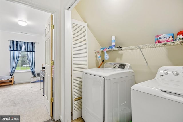  - laundry area featuring separate washer and dryer and light carpet