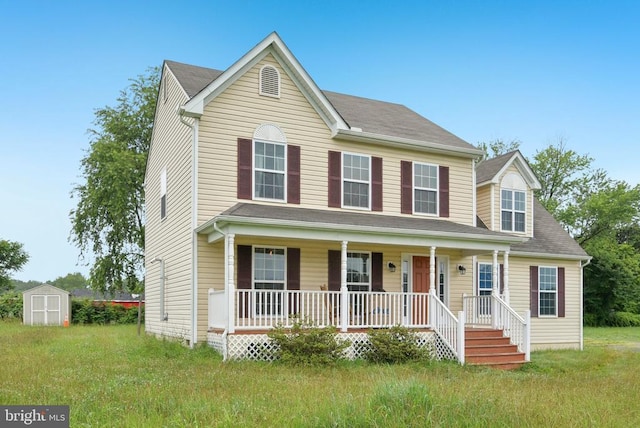  - view of front of property featuring a porch and a shed