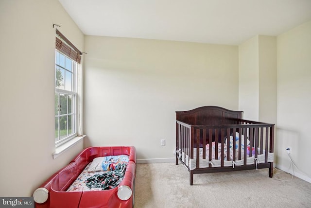  - bedroom featuring multiple windows and carpet floors